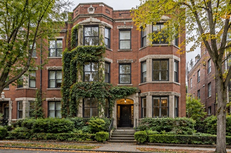 Ivy-covered 1928 red-brick apartment building on Capitol Hill with bay windows